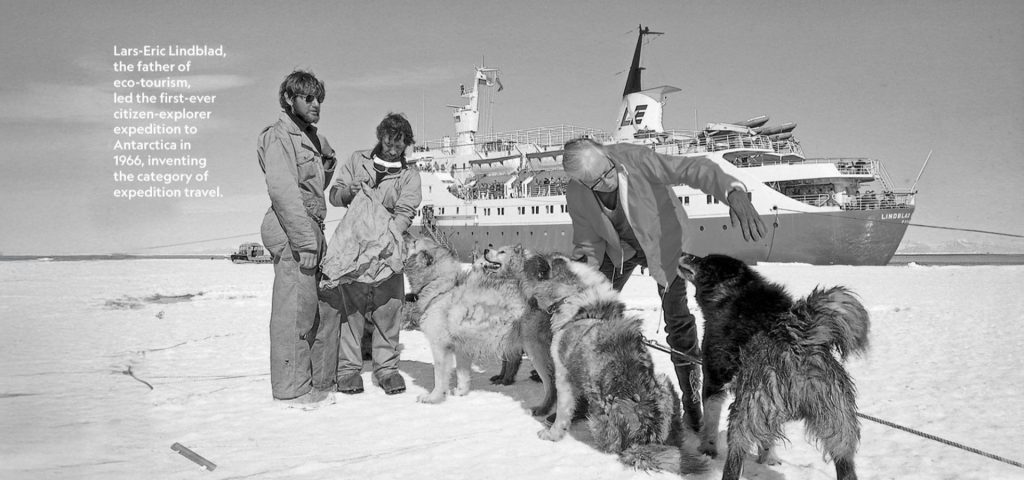 Lars-Eric Lindblad with dogs on ice, historic expedition ship in background, celebrating 60 years of exploration and eco-tourism.
