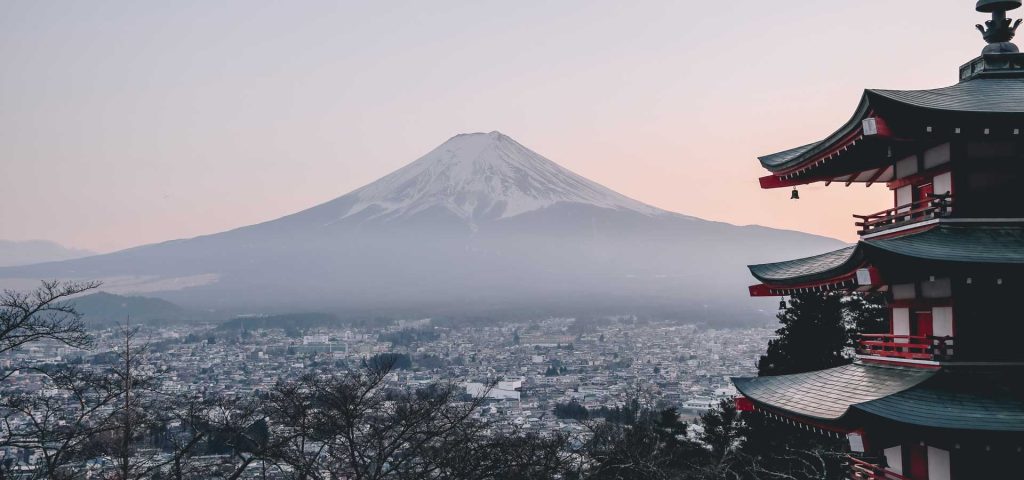Mount Fuji rising above a traditional Japanese pagoda, showcasing Japan's iconic landscape and cultural heritage, ideal for travel inspiration.